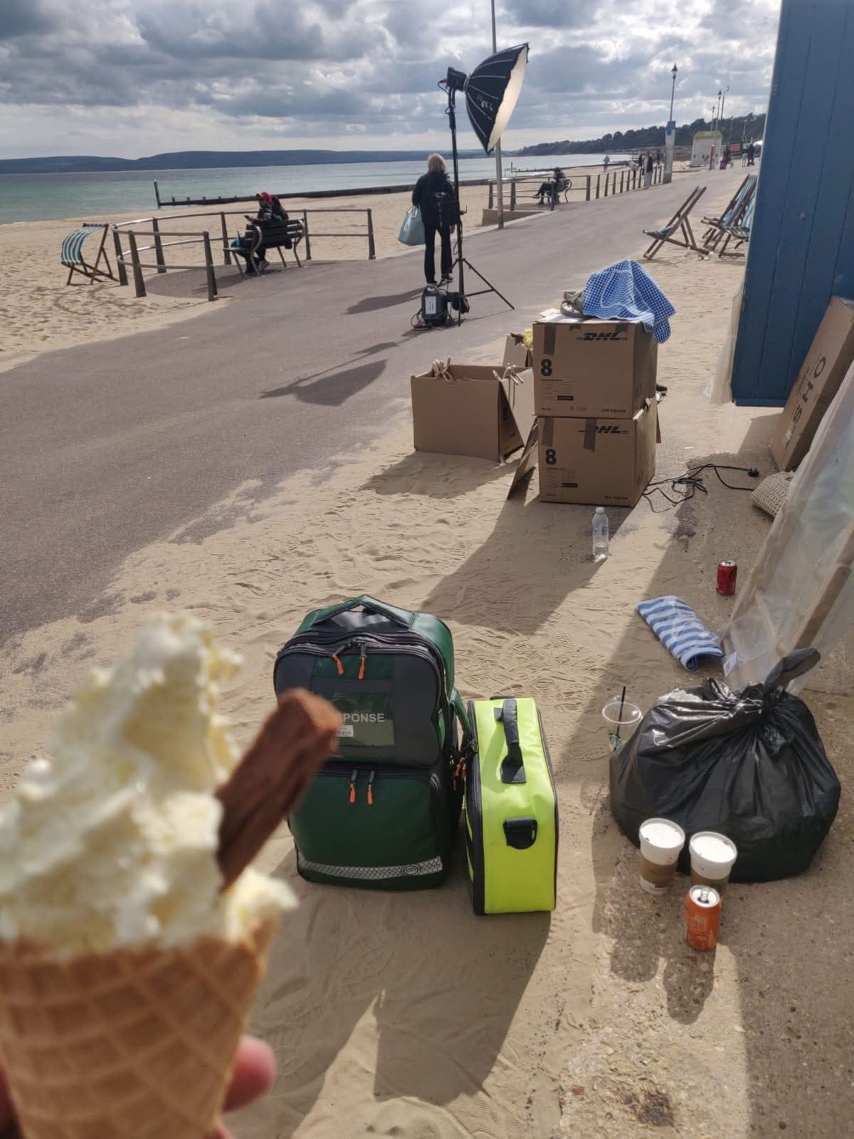 LightMed response bags beside film lighting kit on a seaside promenade location shoot.