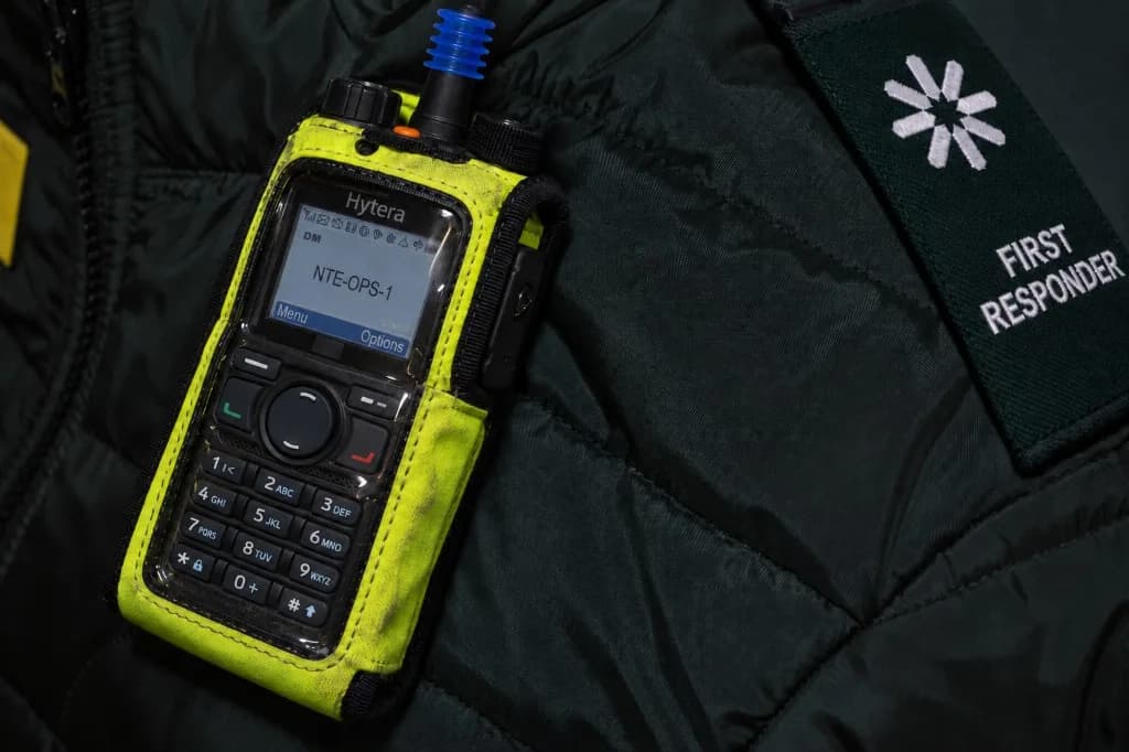 Hytera radio in a high-visibility holster on a LightMed First Responder jacket.